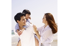 Image Happy family enjoying time together at the beach on a sunny day